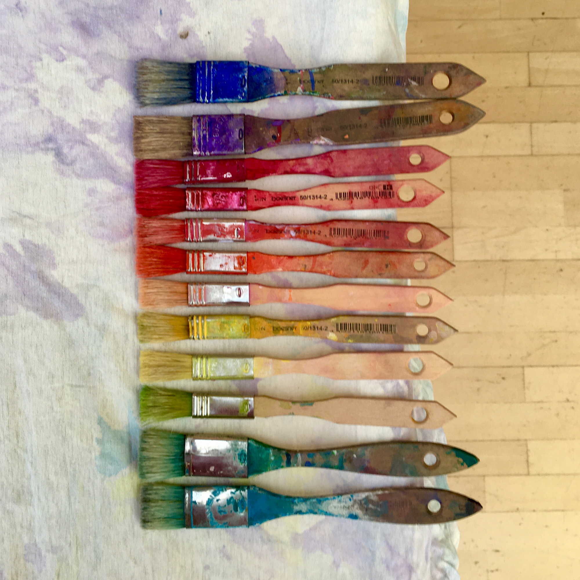 Zwölf Pinsel in Regenbogenfarben